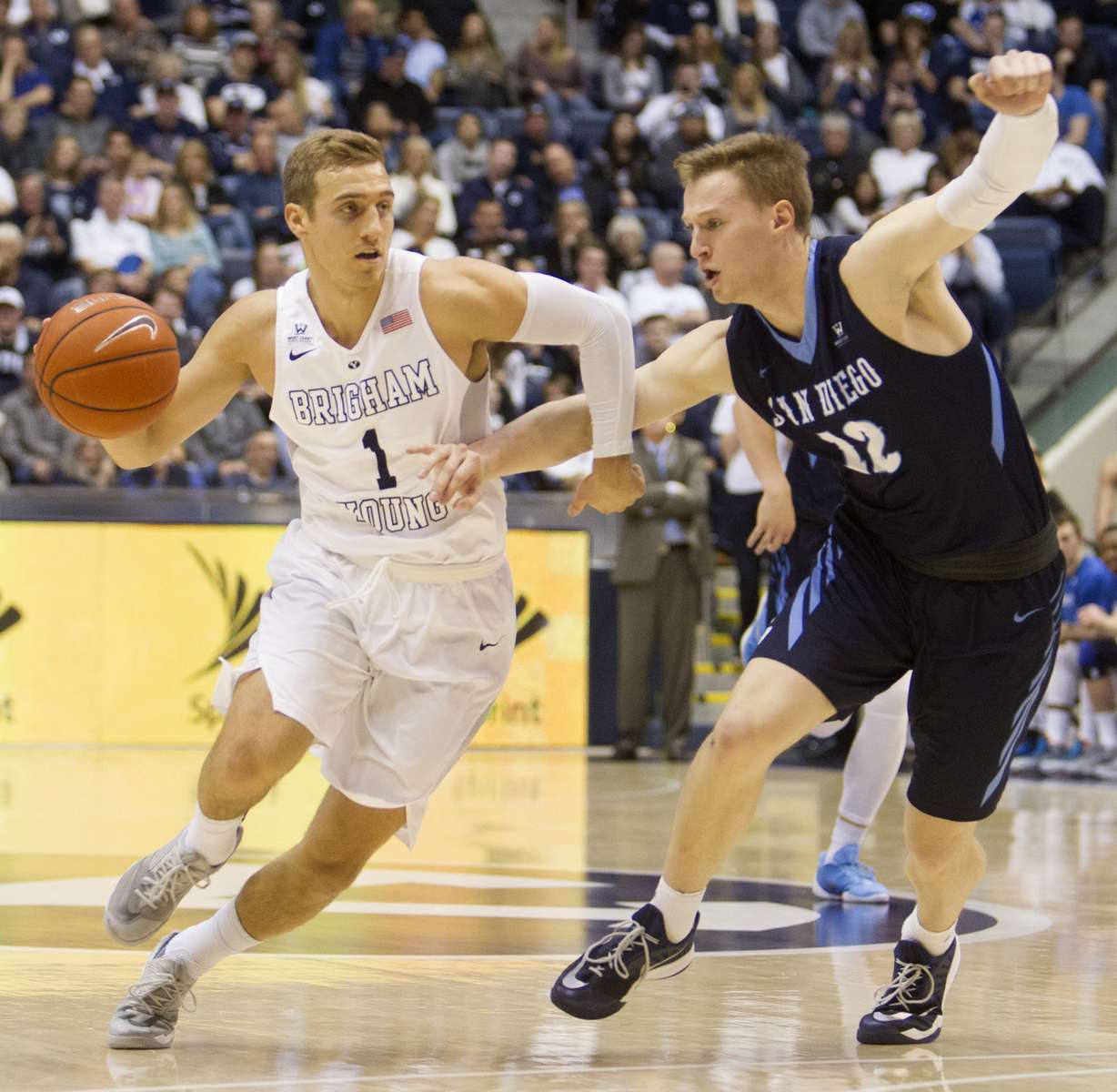 BYU guard Chase Fischer (1) drives against San Diego Toreros forward Cameron Neubauer (12) in the first half of their West Coast Conference matchup at the Marriott Center in Provo, Feb. 20, 2016. (Photo: Luke Franke, Deseret News)