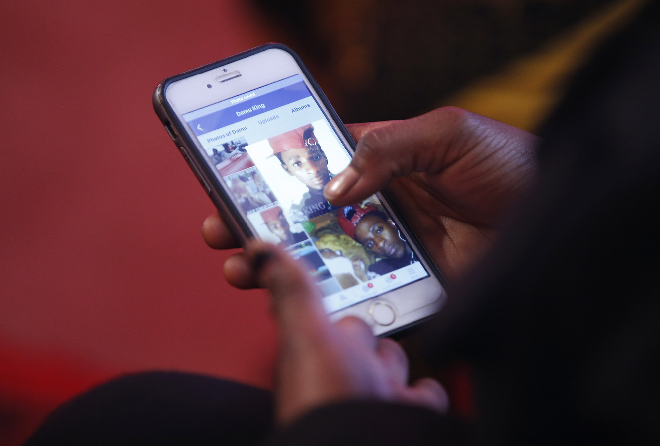 Muslima Waladi looks at photos of her cousin Abdulli Mohamed in Salt Lake City on Sunday, Feb. 28, 2016. Mohamed was shot by police on Rio Grande Street the previous night. (Photo: Jeffrey D. Allred, Deseret News)