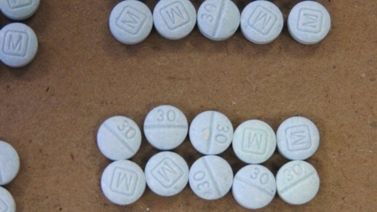 This undated photo provided by the Cuyahoga County Medical Examiner’s Office shows fentanyl pills. A federal court has charged a 31-year-old man, who is from Honduras but living in Salt Lake City, for possessing more than 124,000 pills of fentanyl.