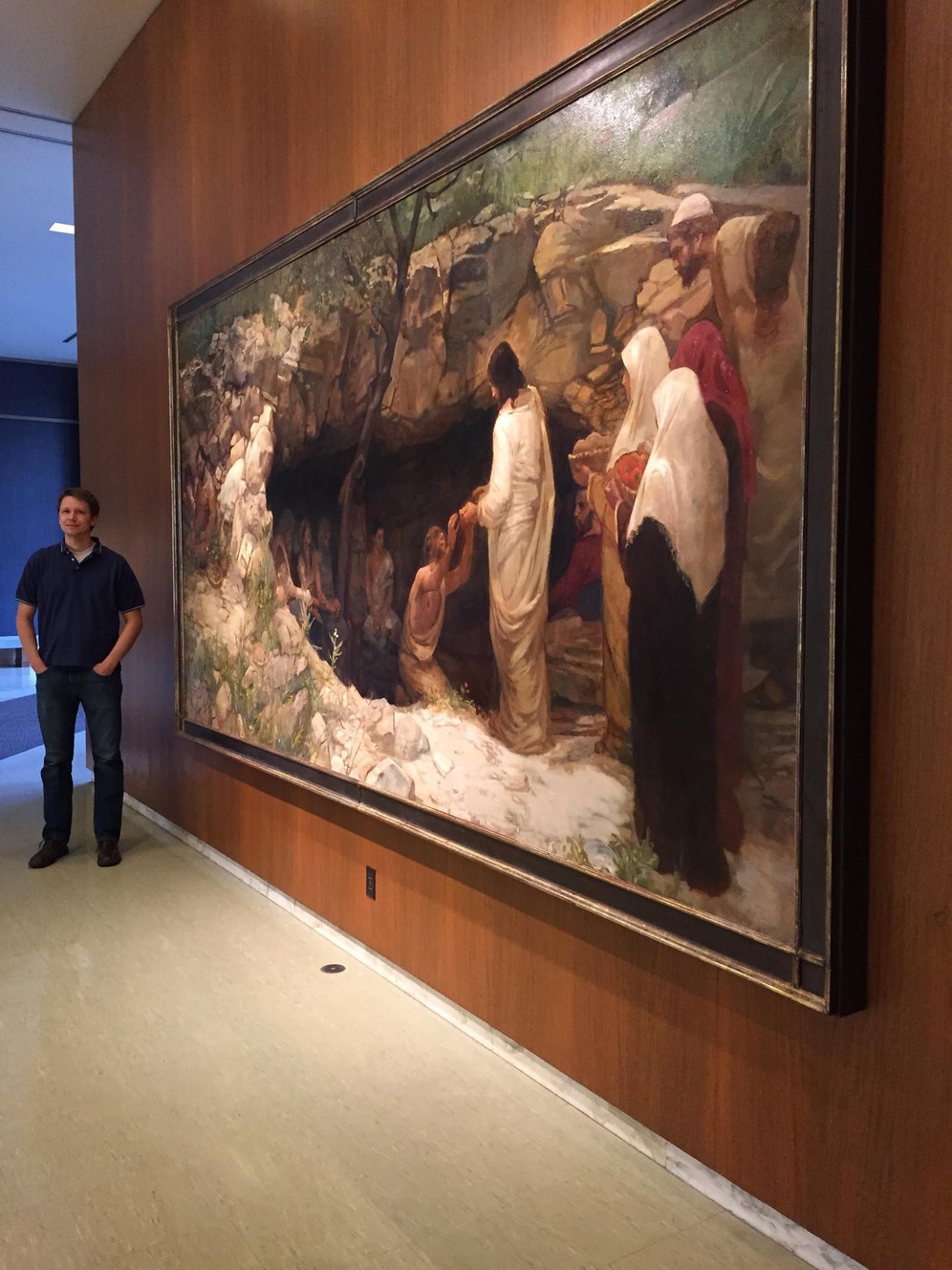 J. Kirk Richards stands next to his piece "Christ Among the Lepers" in the west lobby of the Church Office Building. (Photo: Provided by J. Kirk Richards)