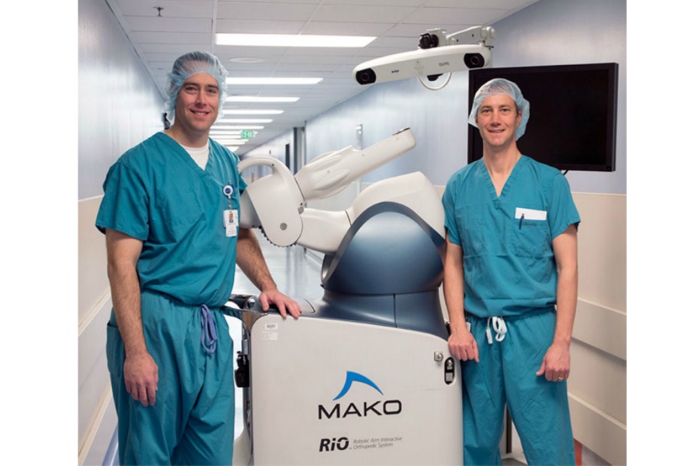 Doctors Schaeffer and Magee in front of MAKOplasty | Courtesy of Salt Lake Regional Medical Center