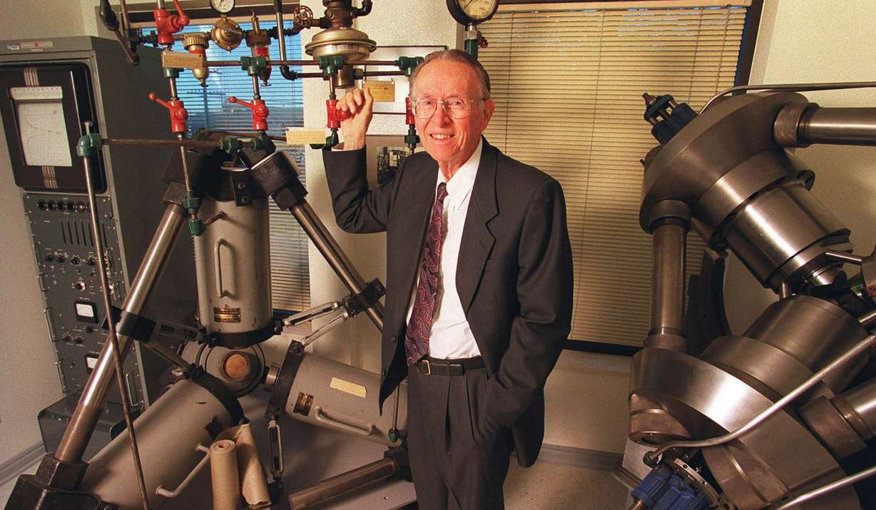 H. Tracy Hall stands with his first tetrahedral press and tetrahedral X-ray press (right), at Novatek in the early 2000s. (Photo: Provided by H.Tracy Hall Foundation and Legacy Books)
