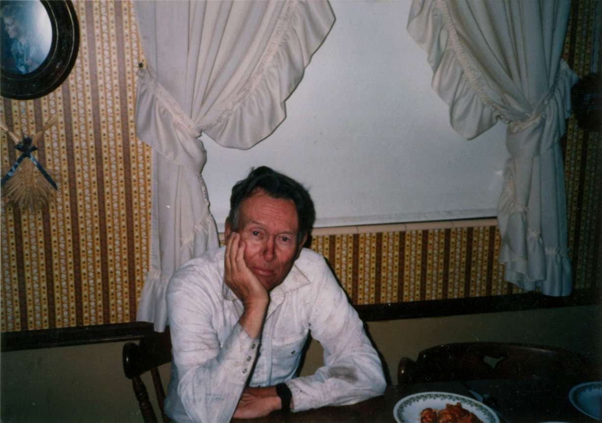 H. Tracy Hall sits after a hard day's work on the farm in the summer of 1989. (Photo: Provided by H.Tracy Hall Foundation and Legacy Books)