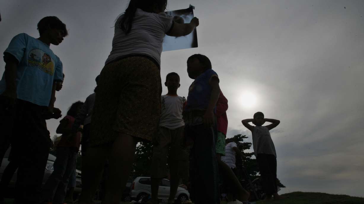 Prayers, cheers as total eclipse darkens swath of Asia