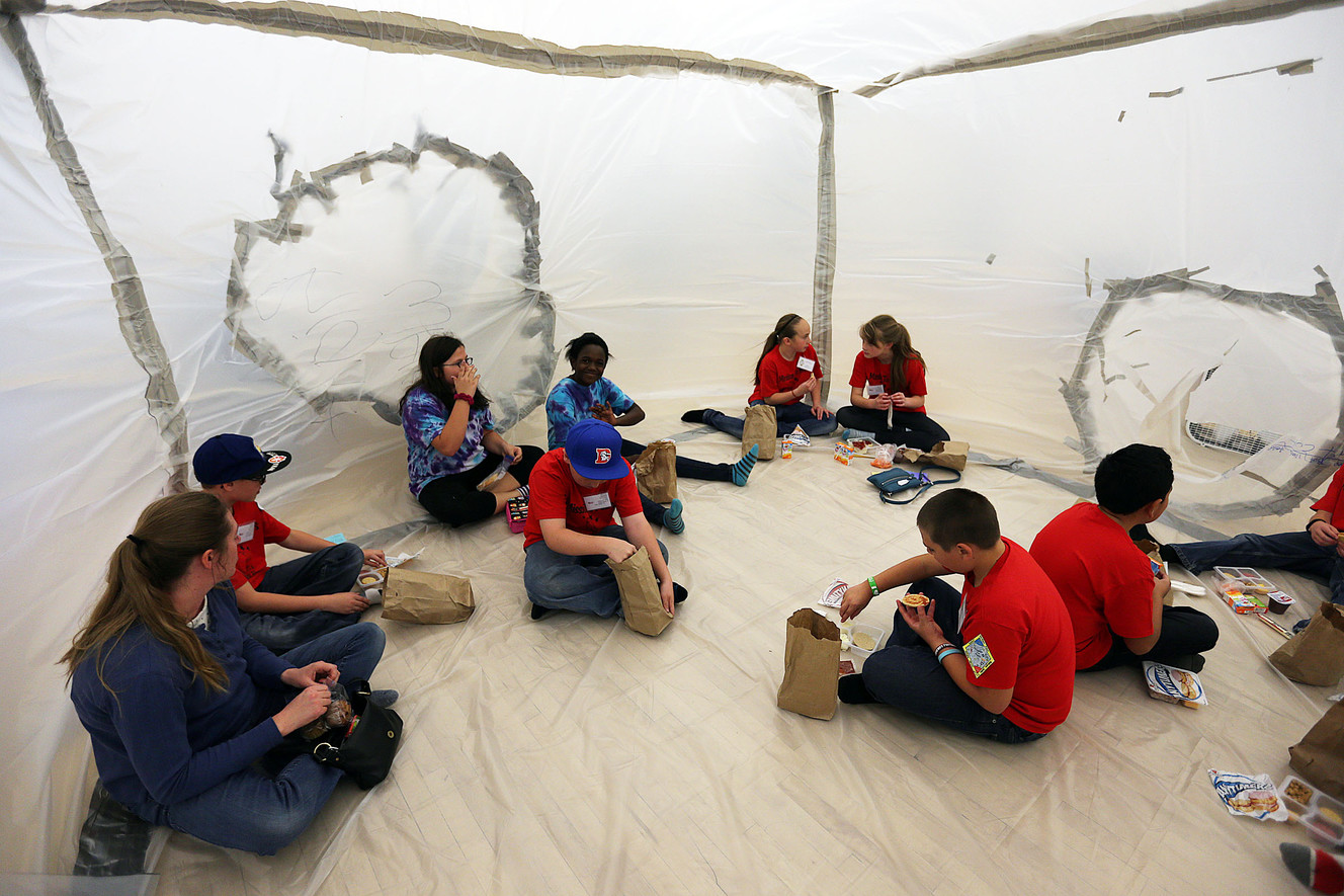 Students and a parent from West Point Elementary eat lunch inside a Mars habitat they built on Wednesday, March 9, 2016. (Photo: Ravell Call, Deseret News)