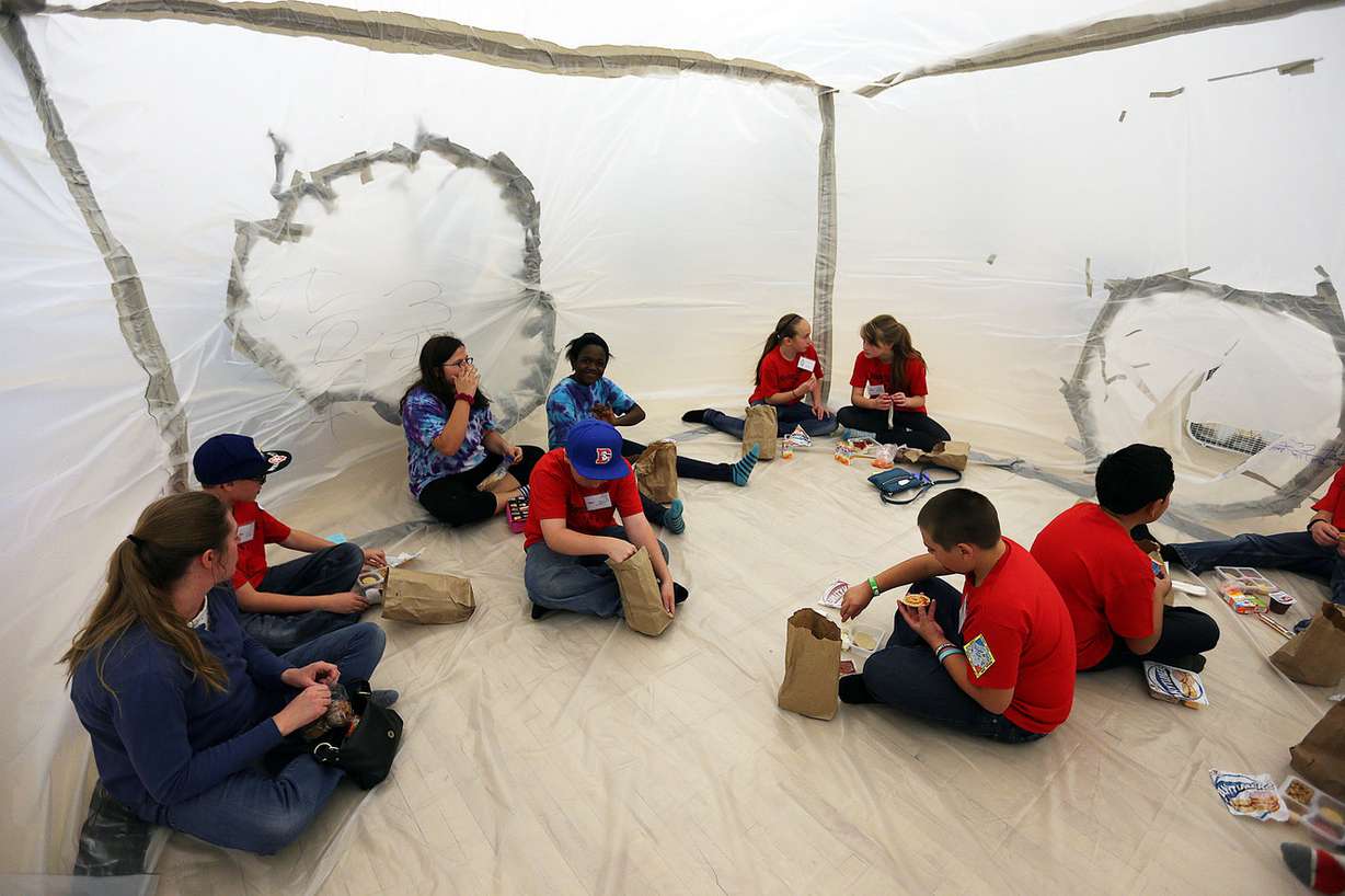 Students and a parent from West Point Elementary eat lunch inside a Mars habitat they built on Wednesday, March 9, 2016. (Photo: Ravell Call, Deseret News)