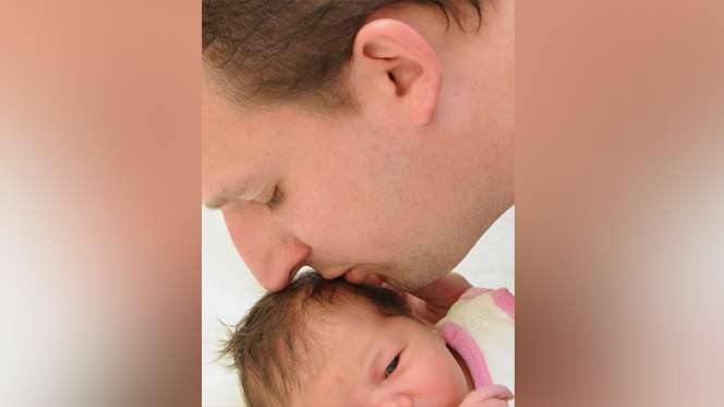 The undated photo provided by his father Juergen Fischenich shows Germanwings crash victim Sven Fischenich kissing his daughter after her birth. Fischenich died when a Germanwings plane from Barcelona to Duesseldorf crashed in the French Alps on March 24, 2015. (Courtesy of Juergen Fischenich via AP)