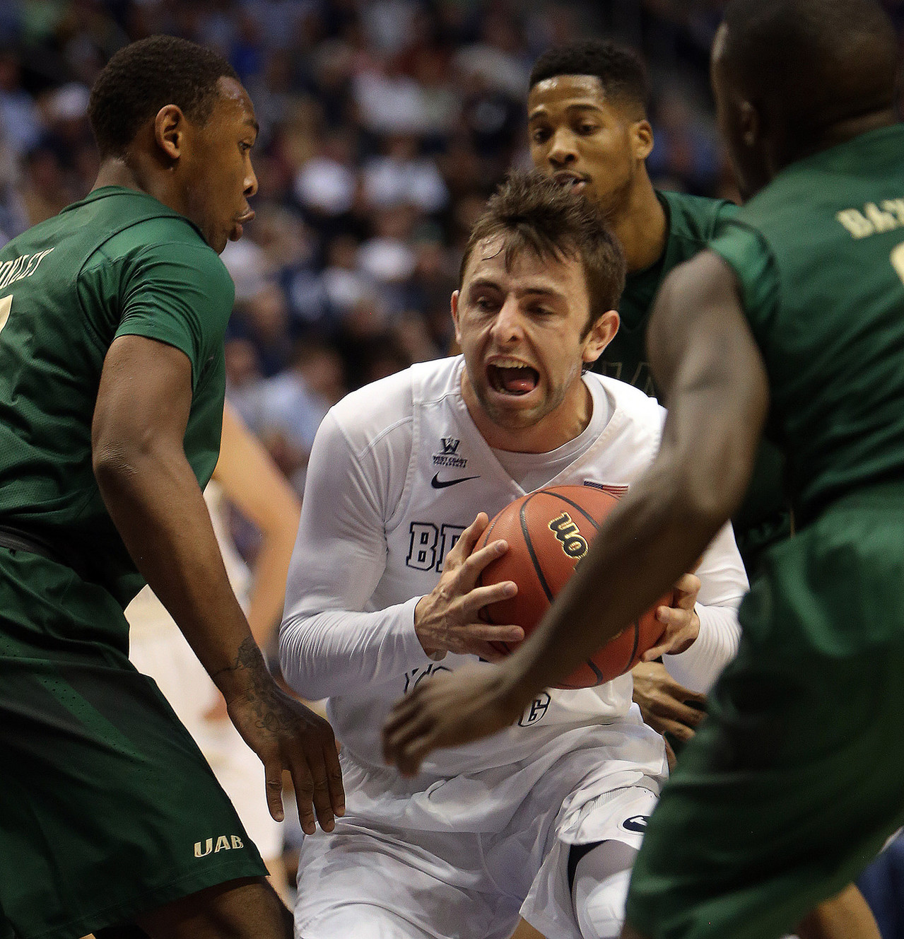 BYU guard Nick Emery, center, tries to maneuver through defenders during the first round of the NIT versus UAB at the Marriott Center in Provo, Wednesday, March 16, 2016. (Photo: Chris Samuels, Deseret News)