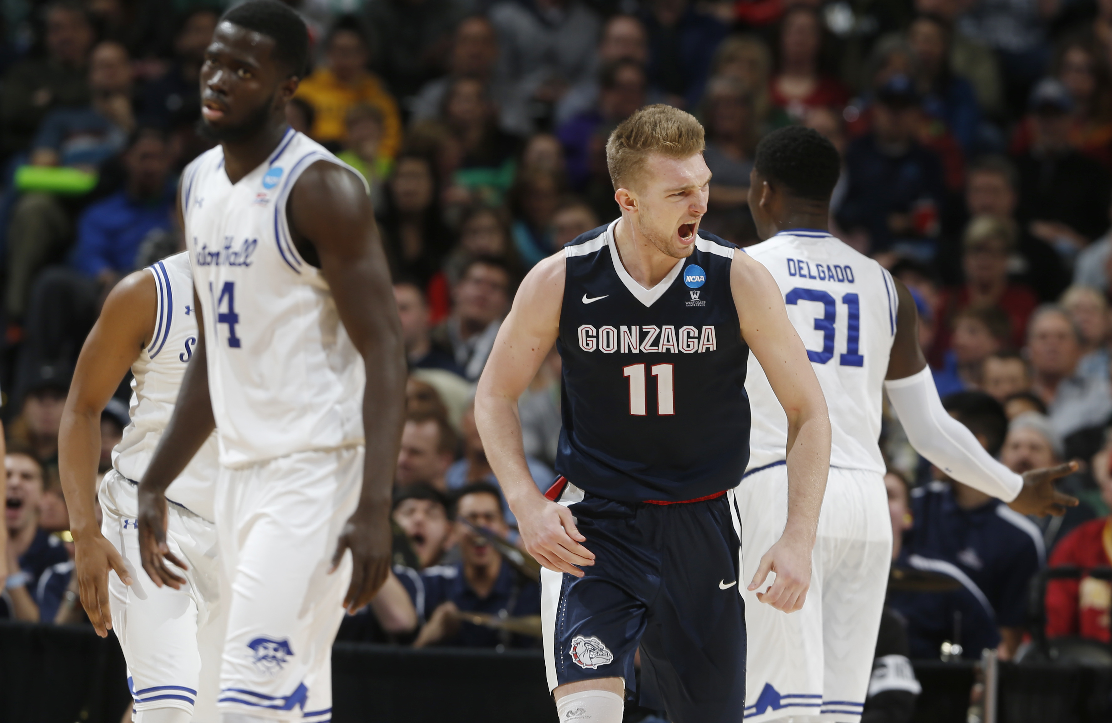 Gonzaga forward Domantas Sabonis, center, celebrates after scoring a basket as Seton Hall guard Ismael Sanogo, left, and forward Angel Delgado turn away during the second half of a first-round men's college basketball game Thursday, March 17, 2016, in the NCAA Tournament in Denver. Gonzaga won 68-52. (Photo: David Zalubowski/AP Photo)