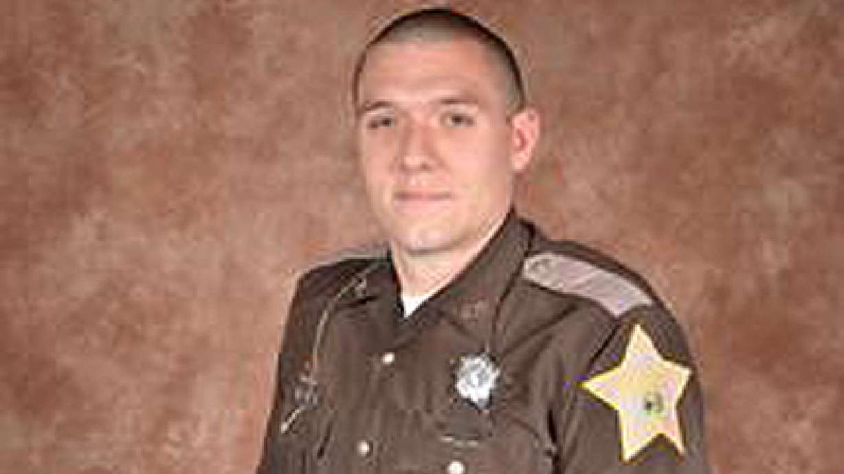 The Latest: Governor: Flags to half-staff for slain deputy