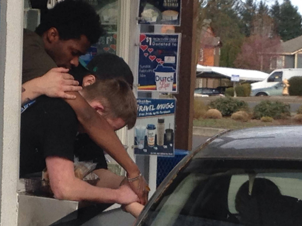Viral photo captures coffee stand employees praying with grieving widow