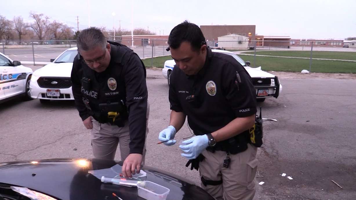 Officer Joe Tan (left) of West Valley Police Department's Crime Suppression Unit investigates following a hit-and-run accident where drugs were found in a vehicle. (Photo: KSL-TV)