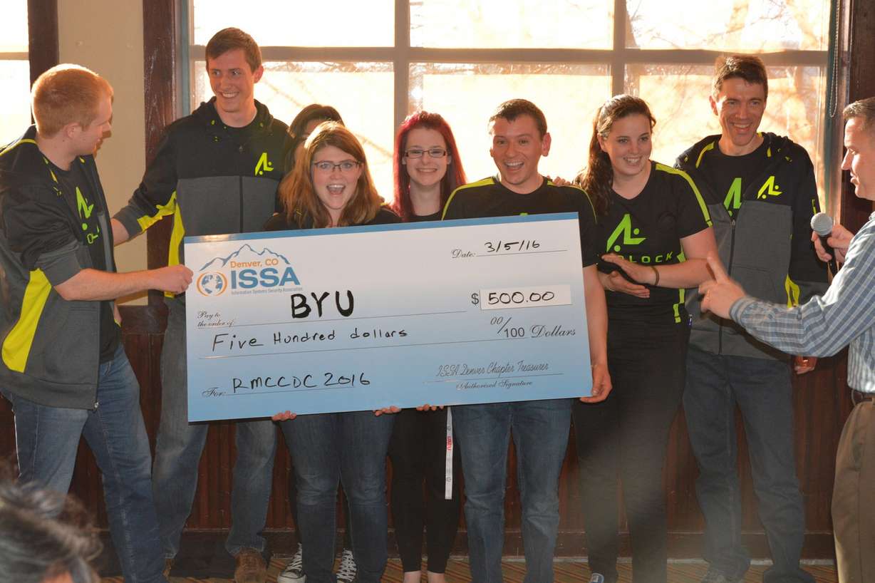Team Autolock poses with the team's first-place check from the 2016 Regional Rocky Mountain Collegiate Cyber Defense Competition.