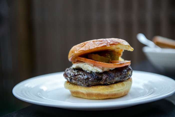 Hugh Acheson’s Cremini-Lamb Burger with charred scallions, Boursin, pickles and tomato on a potato roll at the James Beard Foundation’s Blended Burger Project launch event on March 28, 2016, at the James Beard House. (Photo: Ken Goodman)