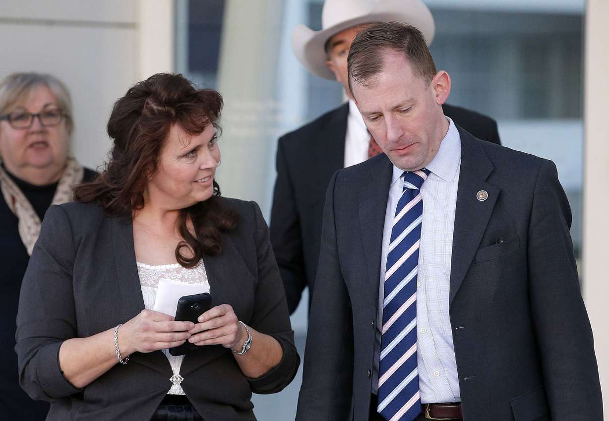 In this Jan. 27, 2016, file photo, Charlene Jeffs, left, the former sister-in-law of Warren Jeffs, talks with with U.S. Justice Department attorney Sean Keveney, as they leave the Sandra Day O'Connor U.S. District Court together after her day of testimony during a federal civil rights trial against two polygamous towns on the Arizona-Utah line in Phoenix. (AP Photo/Ross D. Franklin, File)