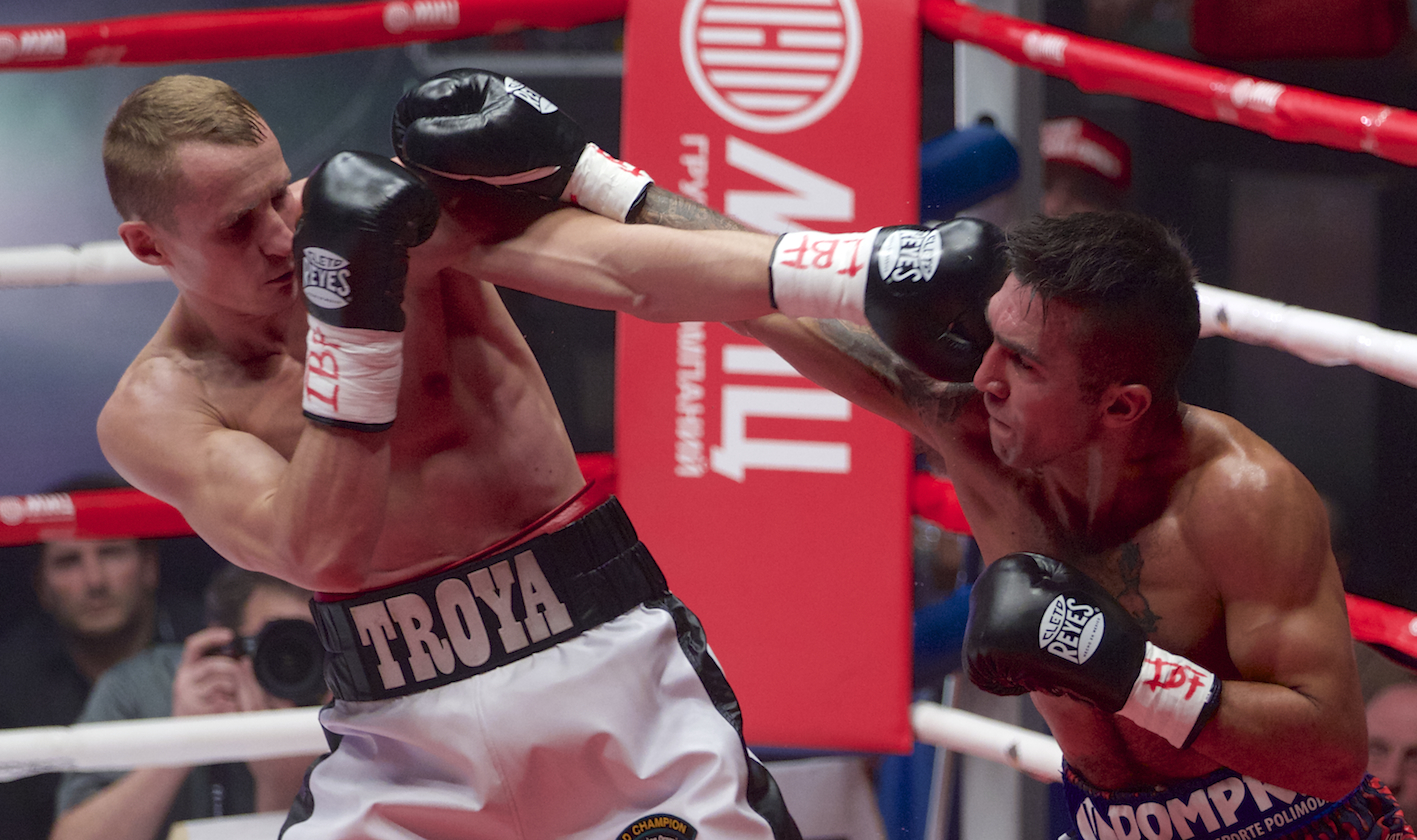 Troyanovsky stops Cuenca to defend light welterweight belts