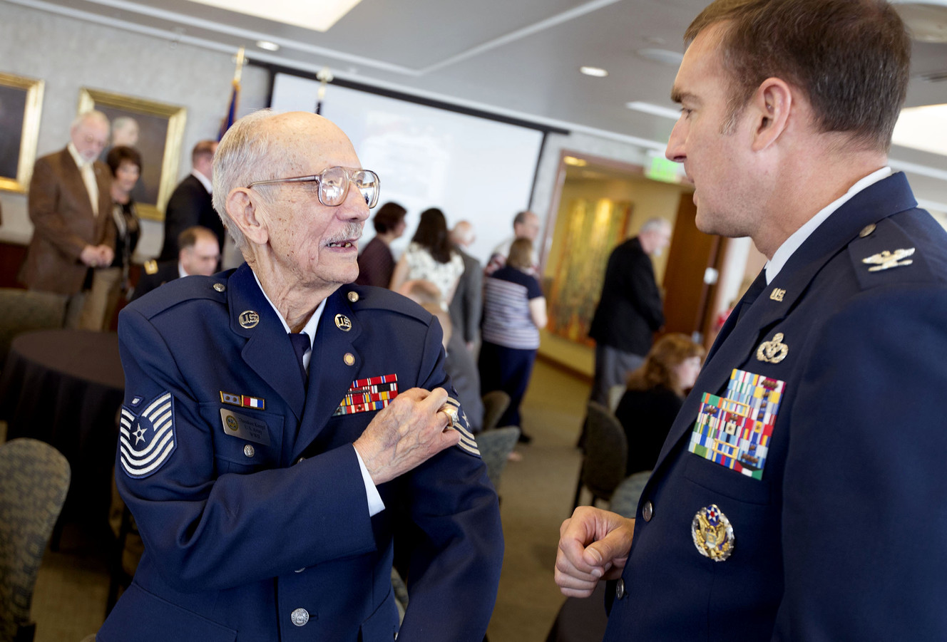 Former prisoner of war Ted Kampf, U.S. Army and U.S. Air Force, speaks with Air Force Col. Wade Lawrence at a ceremony to honor local POWs from World War II, the Korean War and the Vietnam War at the Zion's Bank Building in Salt Lake City on Friday, April 8, 2016. In 1942, Kampf was captured by the Japanese army along with approximately 1,600 other men and thrown aboard an old freighter ship on his way to a destination unknown. On Aug. 15, 1945, one day after the surrender of the Japanese, he was released. (Photo: Laura Seitz, Deseret News)