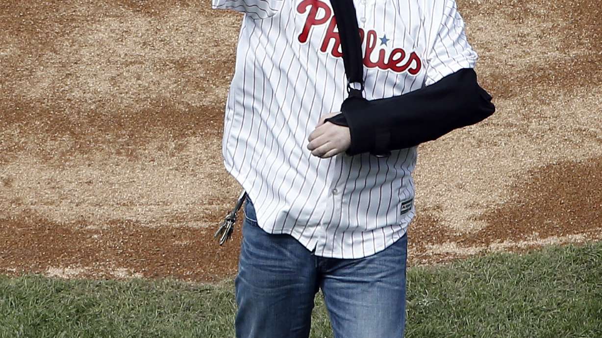 Wounded officer throws first pitch, proposes to girlfriend