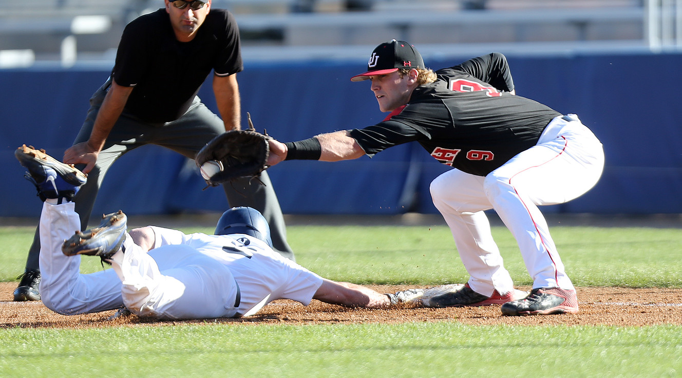 BYU outfielder Brennon Lund, left, dives back to first base as Utah first baseman Hunter Simmons (9) catches the throw during an NCAA baseball game at Miller Field in Provo, Tuesday, April 12, 2016. (Photo: Chris Samuels, Deseret News)