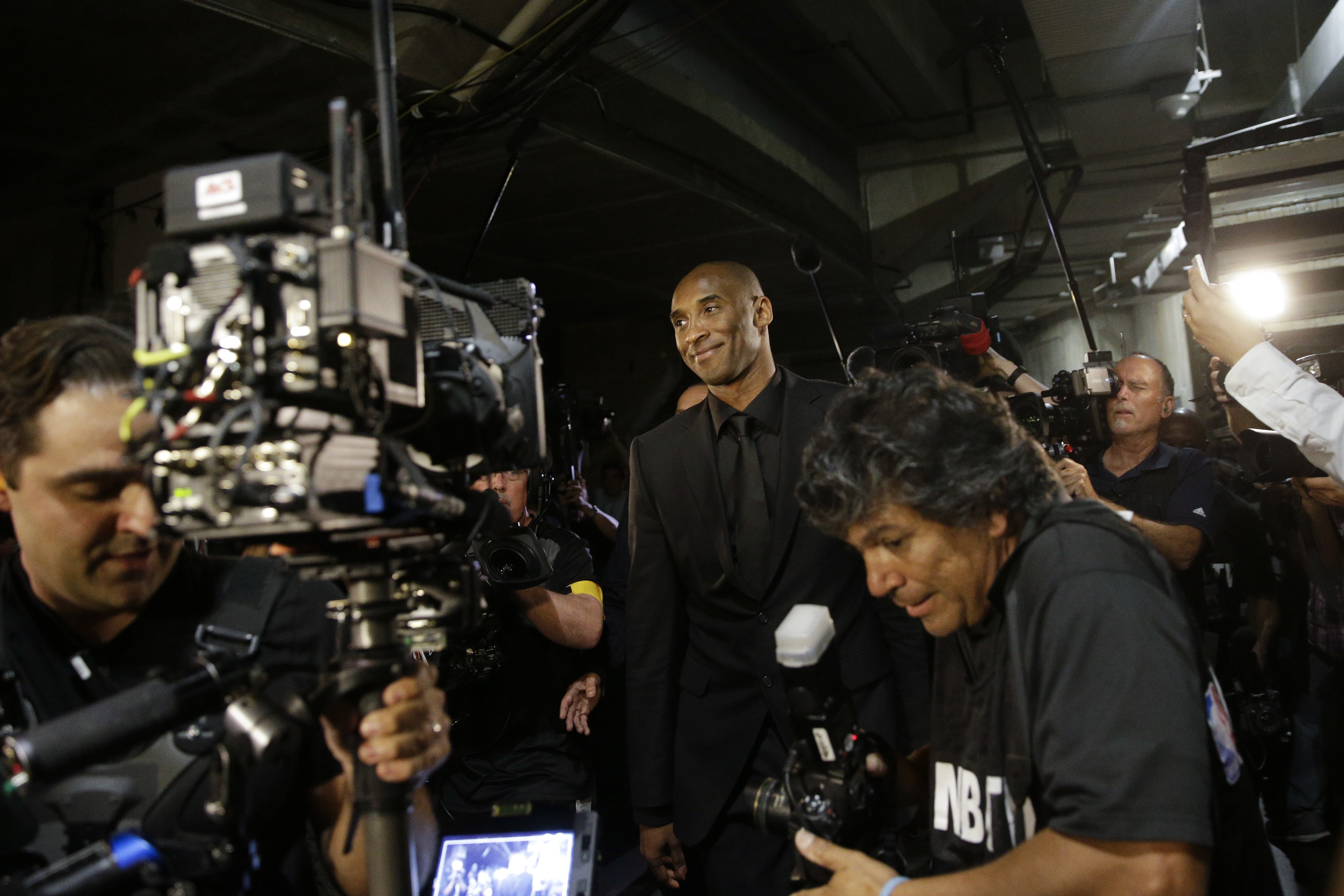 Los Angeles Lakers' Kobe Bryant smiles as he arrives for the last NBA basketball game of his career, against Utah Jazz, Wednesday, April 13, 2016, in Los Angeles. (AP Photo/Jae C. Hong)