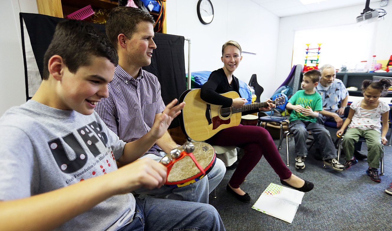 A student participates in a music therapy class with board-certified music therapist Rachel Lighty (playing guitar) at the Millcreek campus of the Utah Schools for the Deaf and Blind in Salt Lake City on Tuesday, April 5, 2016. (Photo: Ravell Call, Deseret News)