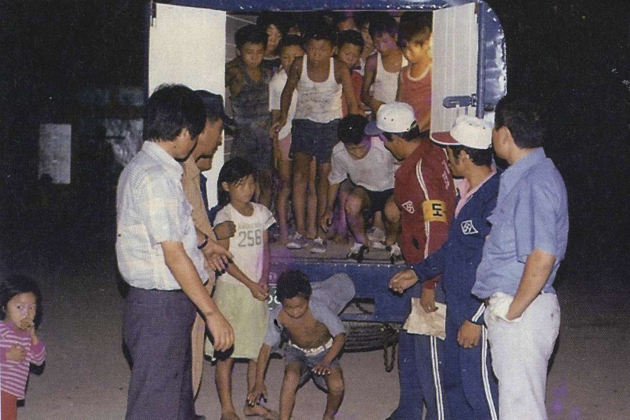 In this undated image provided by the Committee Against Institutionalizing Disabled Persons, a civic group representing the former inmates at the Brothers Home, guards unload children from a truck in Busan, South Korea. An Associated Press investigation shows that rapes and killings of children and the disabled three decades ago at a South Korean institution for so-called vagrants, the Brothers Home, were much more vicious and widespread than previously realized. It also reveals that the secrecy around Brothers has persisted for decades because of a cover-up orchestrated at the highest levels of government.(Committee Against Institutionalizing Disabled Persons via AP)