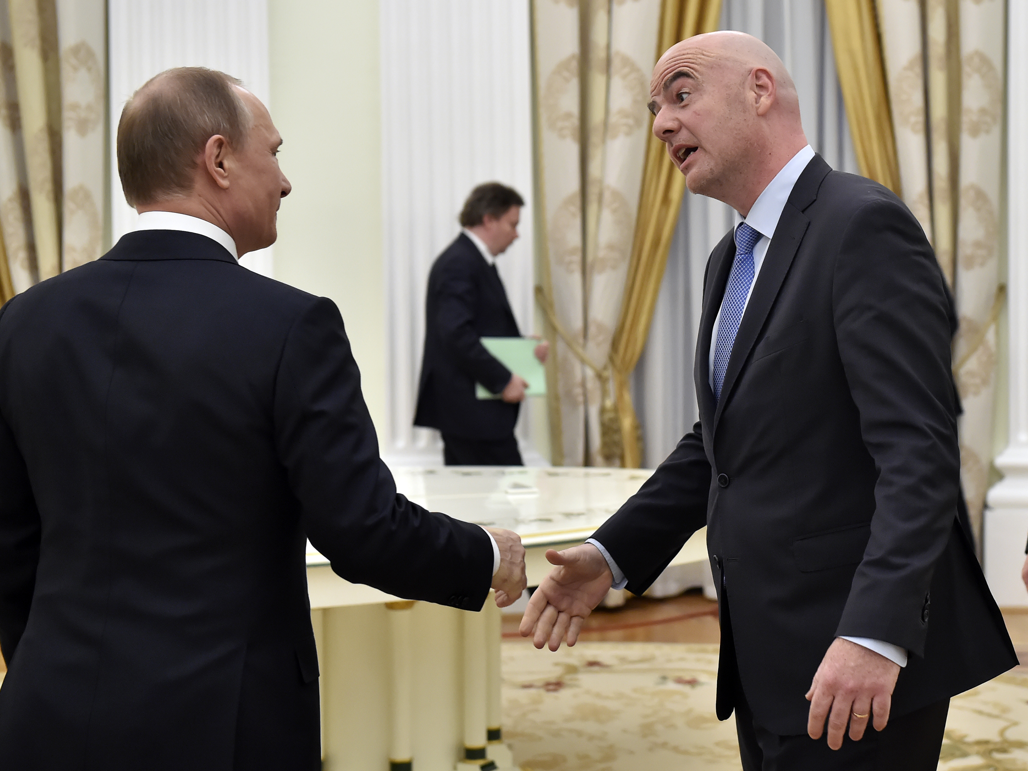 New FIFA head tries out his Russian in meeting with Putin