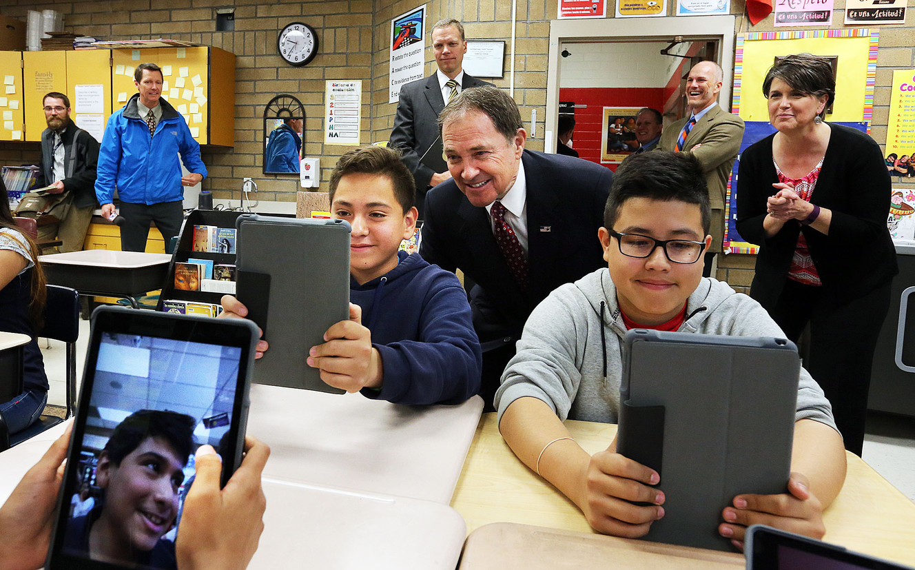Gov. Gary Herbert moves in close as Jackson Elementarytudents Jesse Padilla, left, and Fernando Farias take selfies with their new iPads at the Salt Lake City school on Tuesday, April 26, 2016. (Photo: Ravell Call, Deseret News)