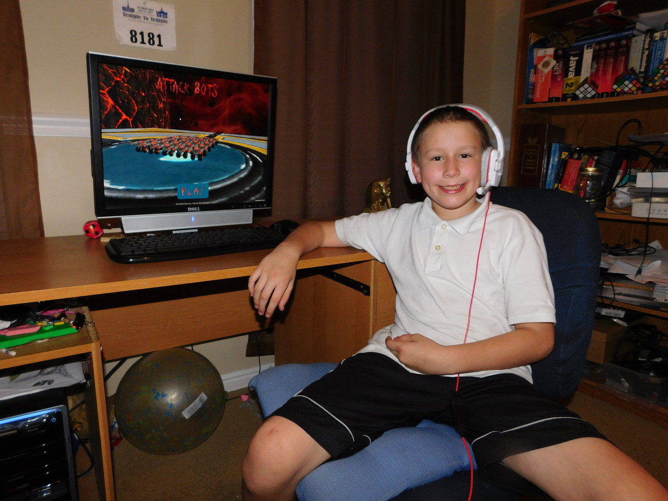 Ryan Worthington sits in front of Attack Bots, the game he created with his father Jonathan Worthington. (Photo: Jonathan Worthington)