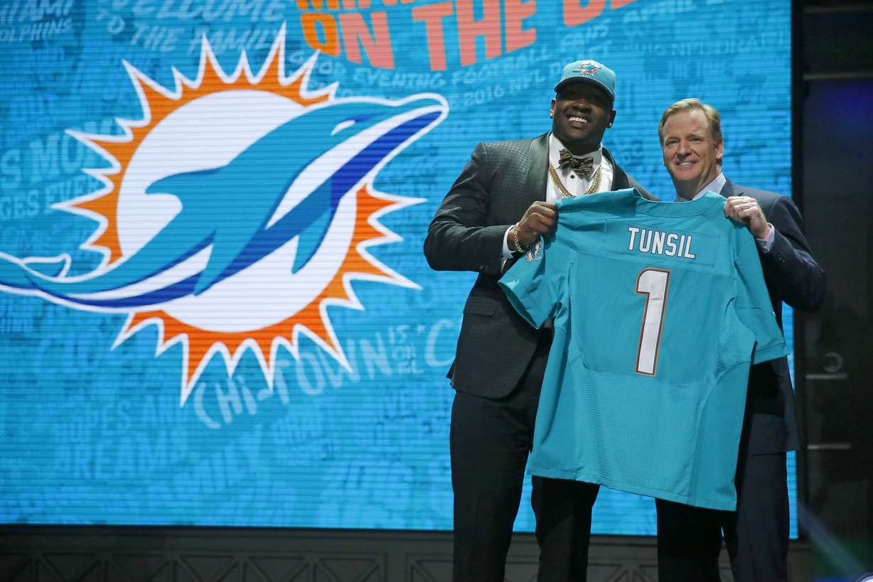 Mississippi’s Laremy Tunsil poses for photos with NFL commissioner Roger Goodell after being selected by the Miami Dolphins as the 13th pick in the first round of the 2016 NFL football draft, Thursday, April 28, 2016, in Chicago. (AP Photo)