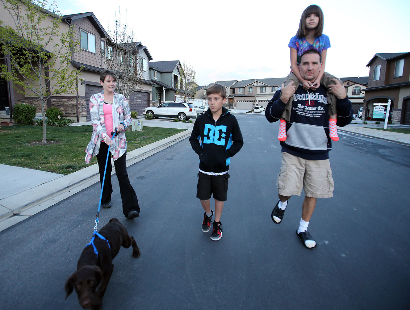 The Crandall family — Kelley, left, Isaak, David and Krysti, on David's shoulders — takes their dog, Oscar, for a walk in the neighborhood near their home in Lehi on Tuesday, April 26, 2016. David and his wife, Kelley, say their son was abused by a day care worker eight years ago. The case has yet to reach a resolution or go to trial. (Photo: Chris Samuels, Deseret News)