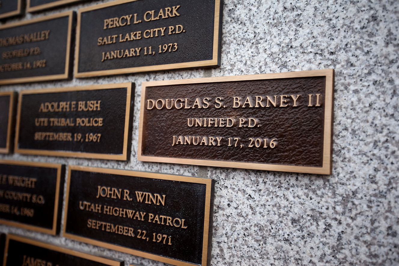 A plaque bearing the name of Unified Police Officer Douglas Barney is added to the wall during the annual memorial to police officers killed in the line of duty at the Capitol in Salt Lake City on Thursday, May 5, 2016. Unified Police Officer Douglas Barney was shot and killed as he responded to a traffic incident in Holladay on January 17, 2016. (Photo: Laura Seitz, Deseret News)