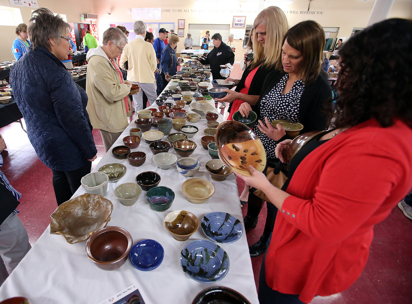 Visitors browse through pottery bowls for sale at an annual fundraiser for Catholic Community Services, which feeds the poor and homeless downtown at St. Vincent de Paul's Dining Hall. in Salt Lake City, Saturday, May 7, 2016. (Photo: Chris Samuels, Deseret News)