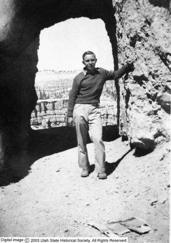 An unidentified CCC enrollee poses for a photograph at a natural arch, somewhere in Southern Utah, dated sometime between 1933 and 1942. (Photo: Photo Courtesy Utah State Historical Society)
