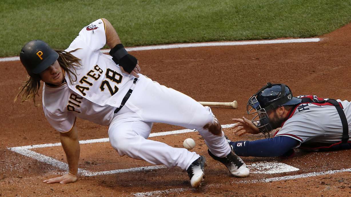Pirates spoil Snitker's debut as manager, top Braves 12-9