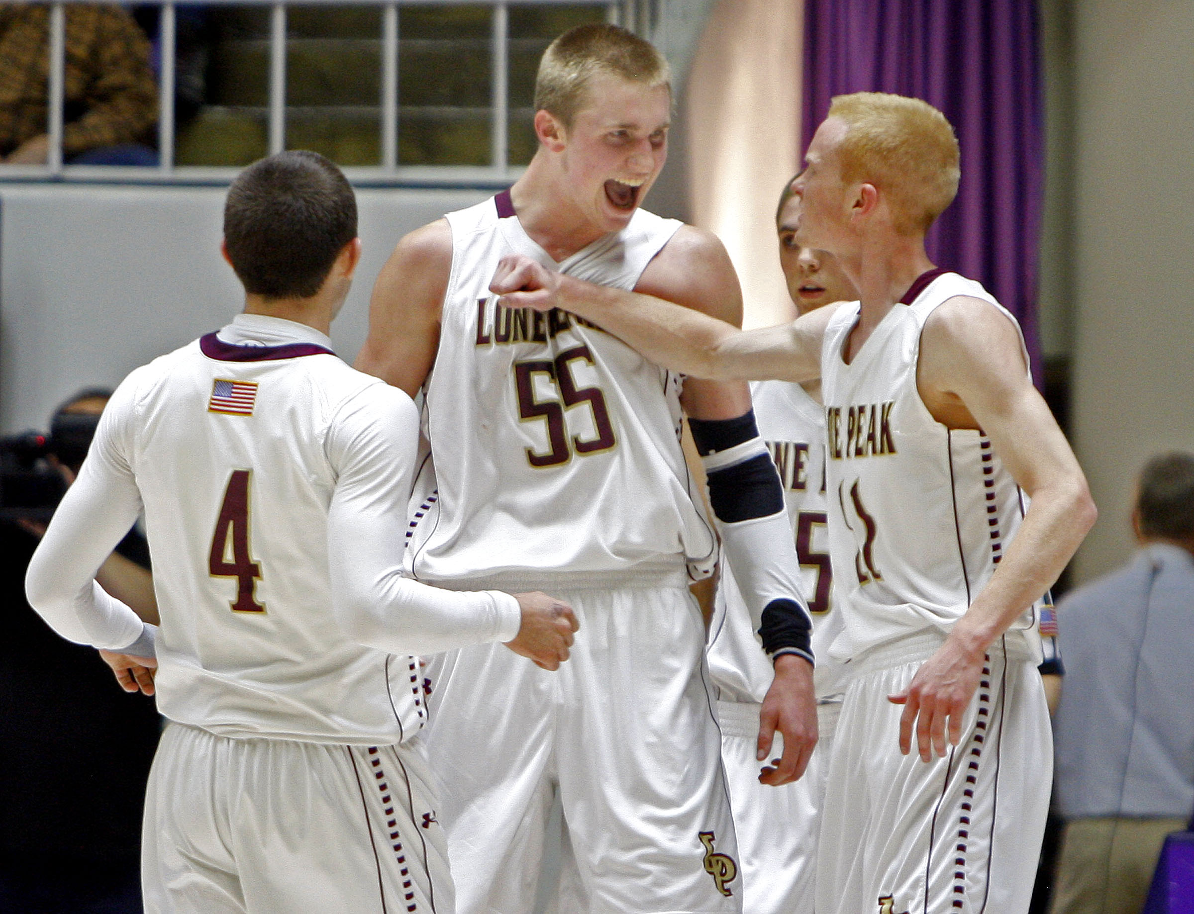 Lone Peak's Nick Emery, Eric Mika and T.J. Haws, left to right, celebrate as Lone Peak High School defeats Davis High School in the state 5A quarterfinals basketball tournament Wednesday, Feb. 27, 2013, in Ogden. (Photo: Tom Smart/Deseret News)