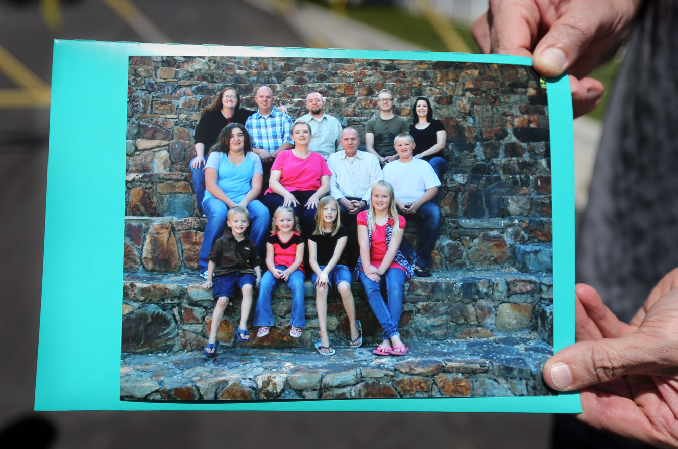 Richard Massey, a spokesperson for Kay Ricks' family, holds a Ricks family portrait during a press conference in American Fork on Wednesday, May 18, 2016. Ricks, his wife, three sons, two of his three daughters-in-law and six grandchildren are in the photo. Ricks, a Utah Transit Authority maintenance worker who was last seen on Thursday, May 12, 2016, was found dead about 16 miles south of Kemmerer, Wyoming on Tuesday, May 17, 2016. (Photo: Kristin Murphy, Deseret News)