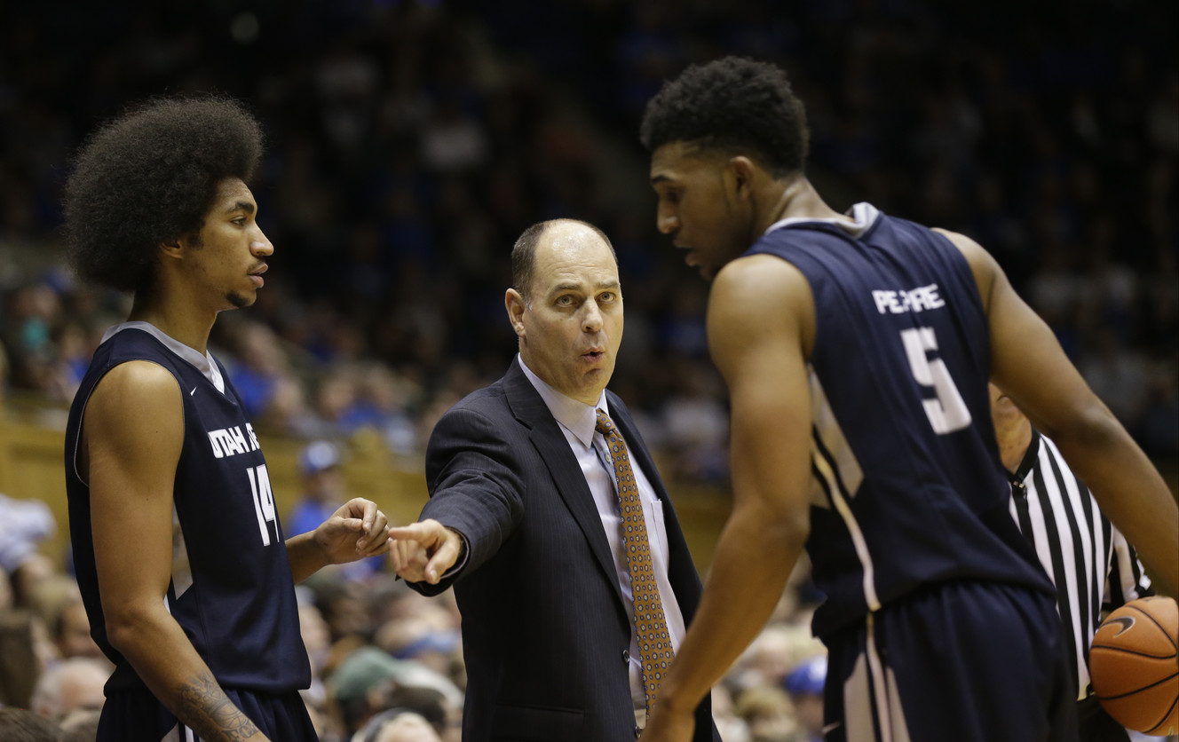 Utah State's Jalen Moore (14) and Julion Pearre (5) speak with coach Tim Duryea during the second half of an NCAA college basketball game in Durham, N.C., Sunday, Nov. 29, 2015. Duke won 85-52. (Photo: Gerry Broome, AP Photo)
