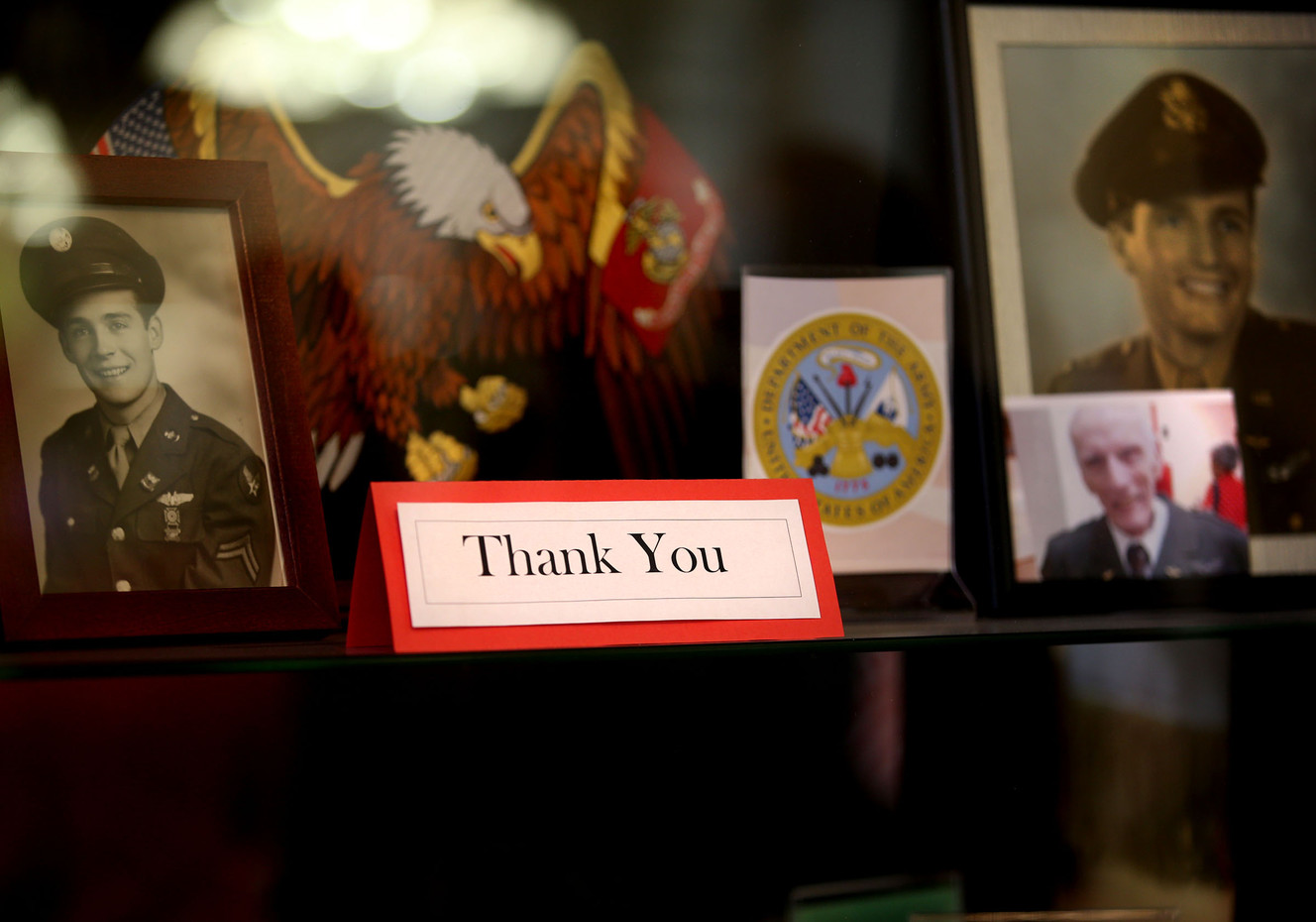 A display case of photographs honors World War II veteran and Army 1st Lt. Dan M. Eastman, 96, at the Olympus Ranch Retirement Community in Murray on Wednesday, May 25, 2016, where he received an Honor Salute from Community Nursing Services. (Photo: Laura Seitz, Deseret News)