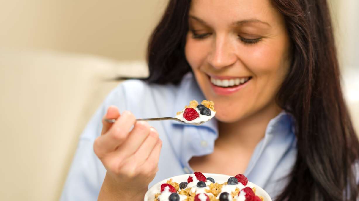 woman fruit yogurt granola healthy