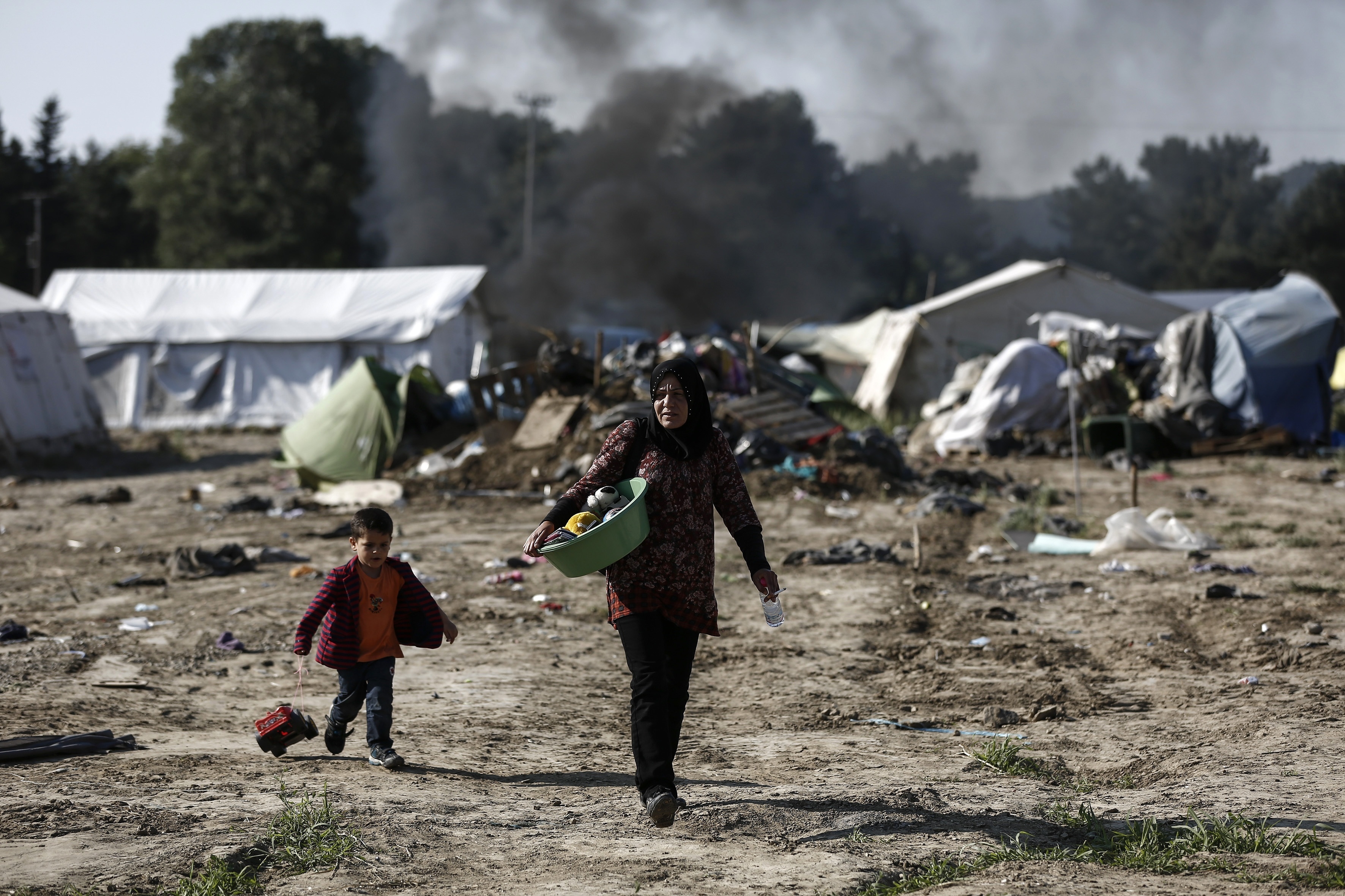 The Latest: IOM eyes closer ties to UN to help migrants