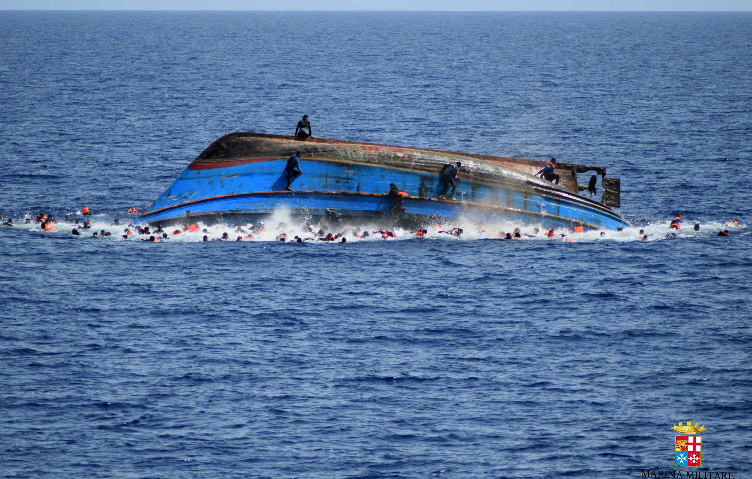 Migrant shipwreck survivor says he was under hull, pal died