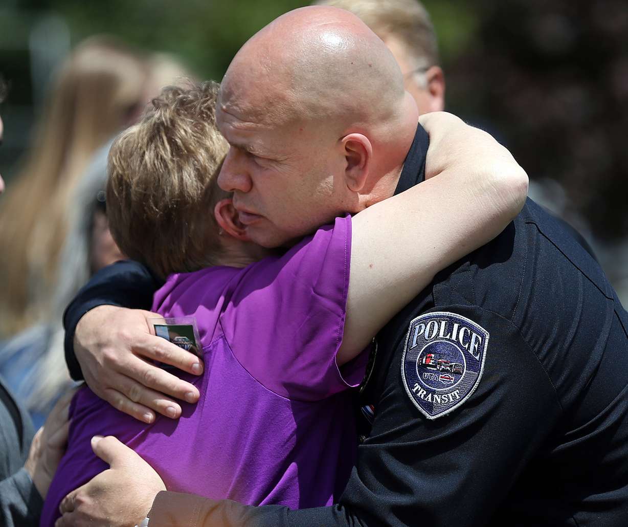 Fred Ross, right, UTA Police Chief, hugs Lorie Ricks, left, widow of Kay Ricks, after funeral services at Lehi City Cemetery in Lehi, Saturday, May 28, 2016. Ricks was a UTA employee who vanished while on the job and was found dead in Wyoming May 17. (Photo: Chris Samuels, Deseret News)