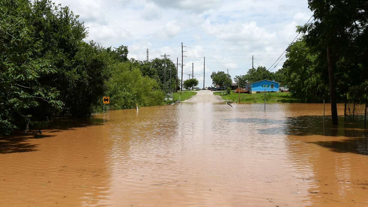 Swollen river feeds flooding near Houston as residents flee