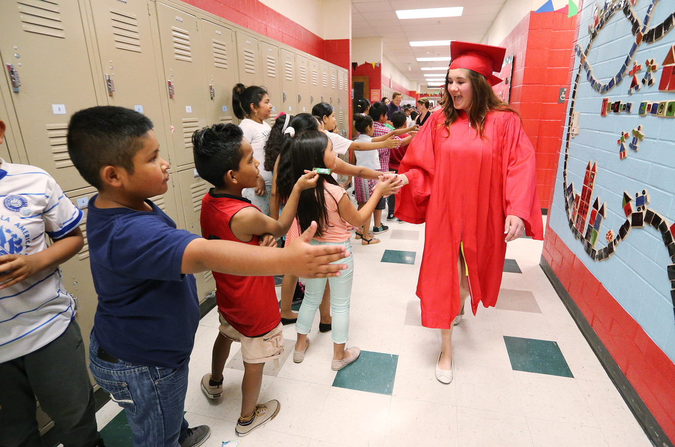 West High School graduate Merissa Bott parades through Jackson Elementary School as she participates in the school’s first ever graduation walk in Salt Lake City, Friday, June 3, 2016. (Photo: Jeffrey D. Allred, Deseret News)