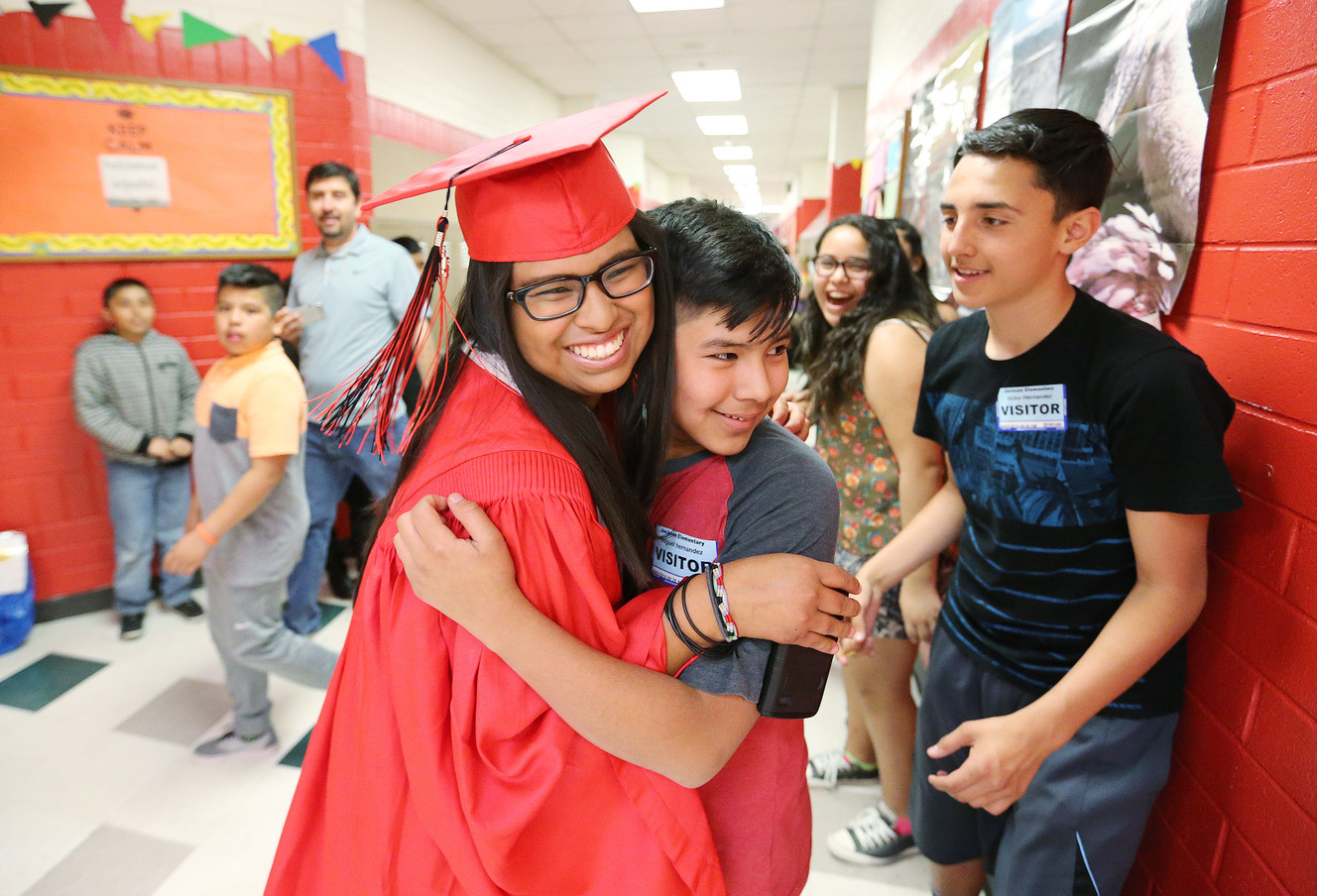 West High School graduates Dulce Hernandez hugs her brother Miguel after parading through Jackson Elementary School as they participate in the school’s first ever graduation walk in Salt Lake City, Friday, June 3, 2016. (Photo: Jeffrey D. Allred, Deseret News)