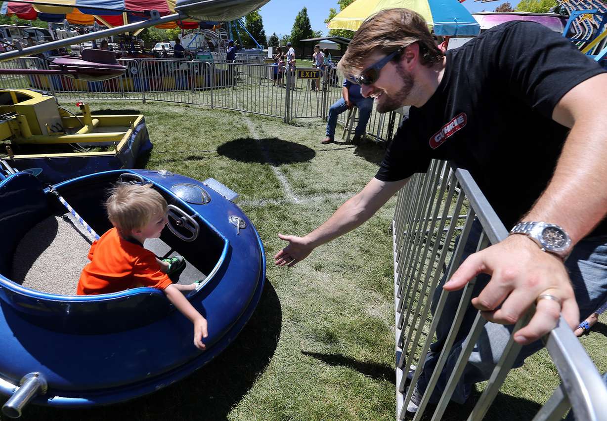 Mike Wiggins, right, of West Jordan, receives a high-five from his son, Bennett, 3, at the SoJo Summerfest in South Jordan on Saturday, June 4, 2016. (Photo: Chris Samuels, Deseret News)