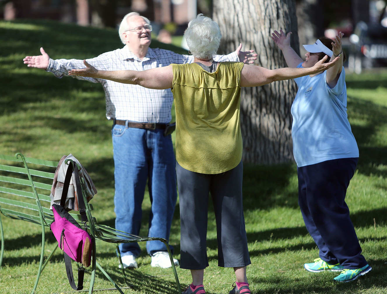 Les Wilson, left, Julie Jacobson and Pat Wilson stretch after walking around Liberty Park in Salt Lake City on Wednesday, June 1, 2016. (Photo: Kristin Murphy, Deseret News)
