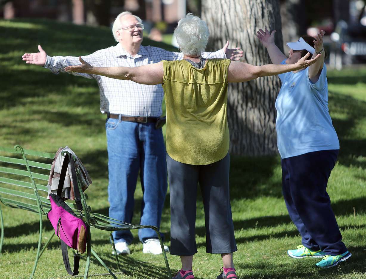 Les Wilson, left, Julie Jacobson and Pat Wilson stretch after walking around Liberty Park in Salt Lake City on Wednesday, June 1, 2016. (Photo: Kristin Murphy, Deseret News)