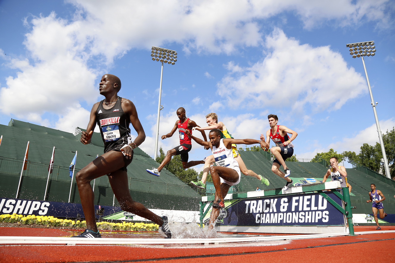 Louisville's Edwin Kibichiy, left, leads the pack during a 3,000-meter steeplechase semifinal at the NCAA outdoor track and field championships in Eugene, Ore., Wednesday, June 8, 2016. Kibichiy finished first. (AP Photo/Ryan Kang)